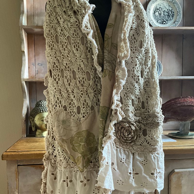 Lace vest with crochet details and rose
