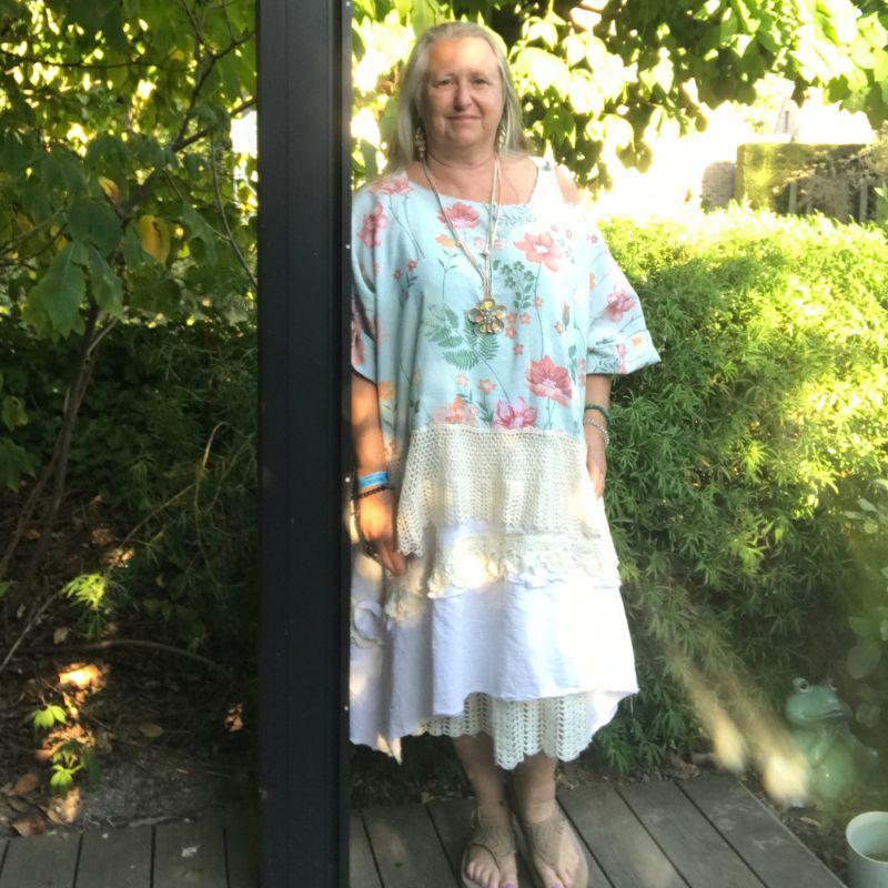 Floral tunic with lace layers, worn in the garden